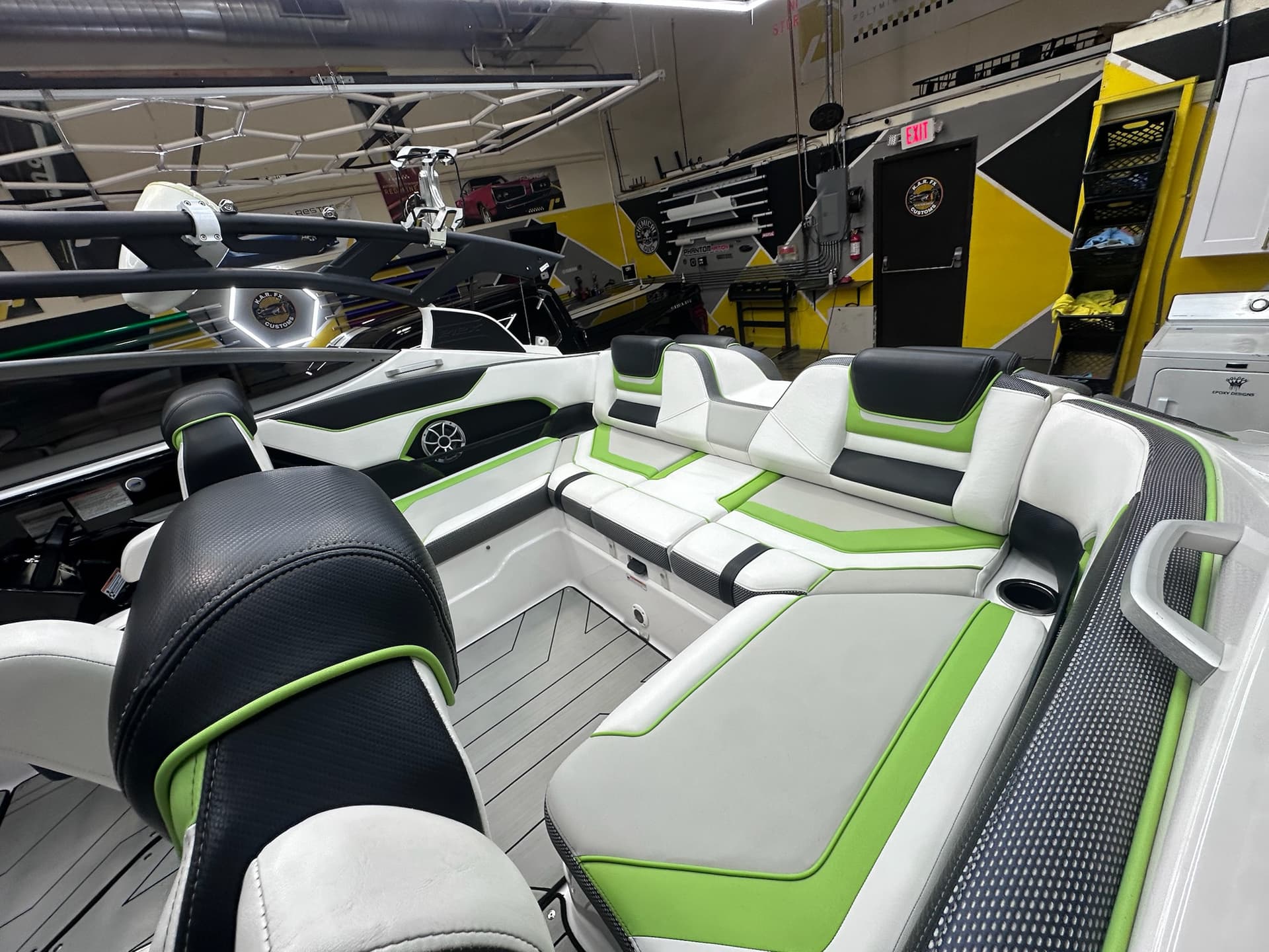 Green and white boat inside the KAR FX Customs workshop